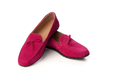 Pink suede woman's moccasins shoes. Studio shot over white backgroundの写真素材