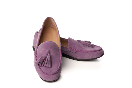 Lilac suede woman's moccasins shoes. Studio shot over white backgroundの写真素材