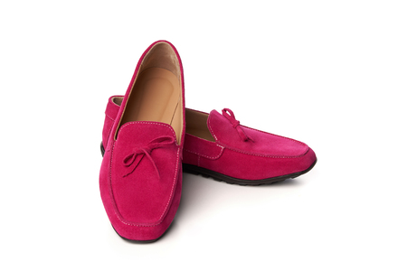 Pink suede woman's moccasins shoes. Studio shot over white backgroundの写真素材
