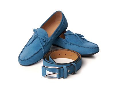 Blue suede man's moccasins shoes with a belt. Studio shot over white backgroundの写真素材