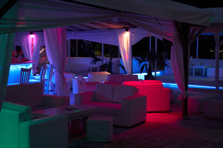 Beach bar in the evening with colorful lightingの写真素材