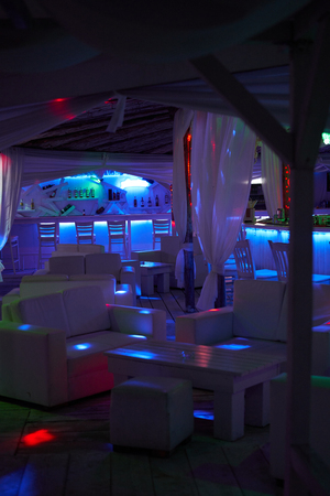 Beach bar in the evening with colorful lightingの写真素材