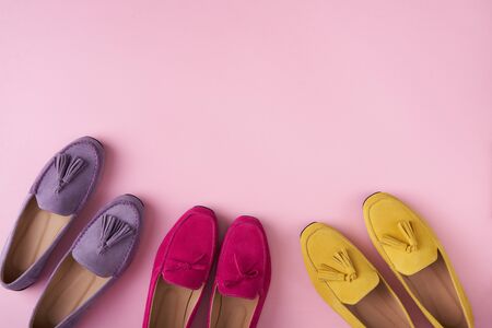 Multicolored suede moccasins shoes with copy space, over pink background, top viewの写真素材
