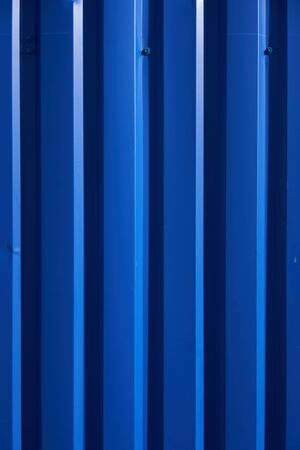 Container pattern. Corrugated metal profiled panel. Metal rivets. Background of blue metal siding, corrugated iron sheet for exterior decorationの写真素材