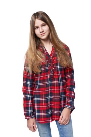 Teen girl in checkered shirt standing casually over white backgroundの写真素材