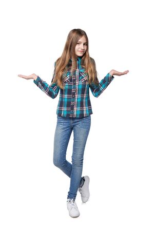Full length teen girl in checkered shirt standing over white background shrugging her shouldersの写真素材
