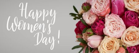 Congratulation text of Happy Women's Day over beautiful bright pink roses and tulips backgroundの写真素材
