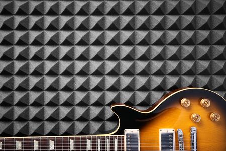 Top view of electric guitar on acoustic foam panel background, closeupの写真素材