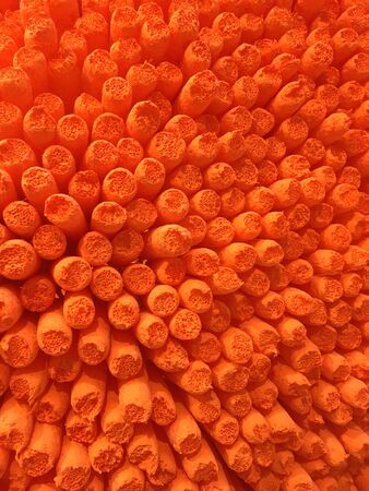 Macro abstract orange background made of artificail sticksの写真素材
