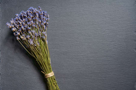 Top view of a bunch of lavender flowers on stone surfaceの写真素材