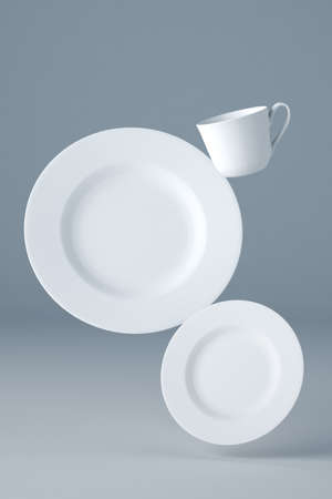 Mockup of two white plates and a cup for your design or logo levitating on blue backgroundの写真素材