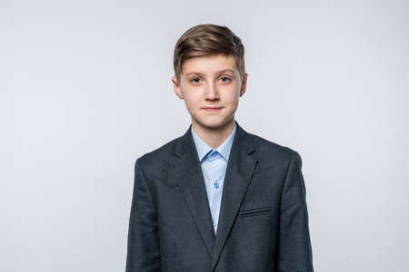 Portrait of a school boy in a jacket, front viewの写真素材