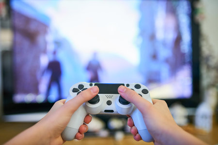 Girl playing video game with joystick at homeの写真素材
