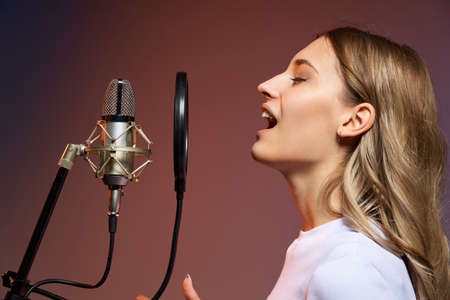 Closeup profile portrait of young Caucasian girl looking forward at blank copy space, studio shotの写真素材