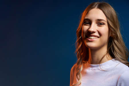 Closeup portrait of young Caucasian girl looking at camera, dual light studio portrait with copy spaceの写真素材