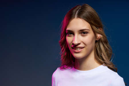 Closeup portrait of young Caucasian girl looking at camera, dual light studio portrait with copy spaceの写真素材