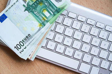 E-commerce, e-banking concept. EU euro banknotes on computer keyboardの写真素材