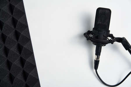 Flat lay of microphone and acoustic foam panel, over white backgroundの写真素材