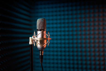 Studio condenser microphone on acoustic foam panel backgroundの写真素材