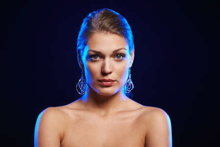 Closeup of young beautiful woman over black backgroundの写真素材
