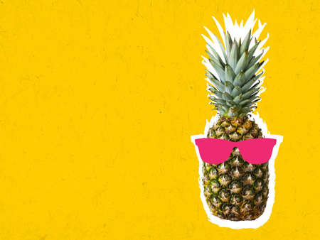 Contemporary art collage of pineapple wearing sunglasses on bright backgroundの写真素材