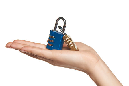 Human hand holding two Combination Padlocks on palm, isolated on whiteの写真素材