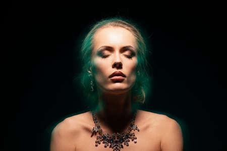 Portrait of beautiful woman with necklace with colorful stonesの写真素材