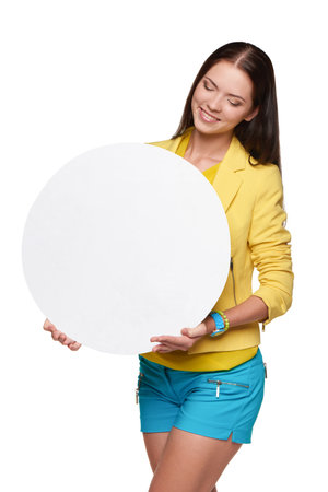 Happygirl in yellow and blue, holding empty circle whiteboard for text or productの写真素材