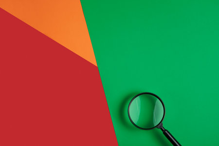 Magnifying glass on three color background with negative space for your text or productの写真素材