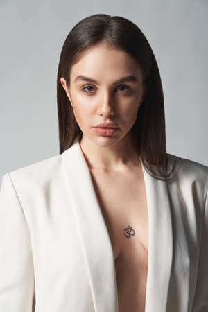 Fashion portrait of beautiful brunette woman in white jacketの写真素材