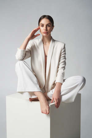 Fashion portrait of beautiful brunette woman in white jacketの写真素材