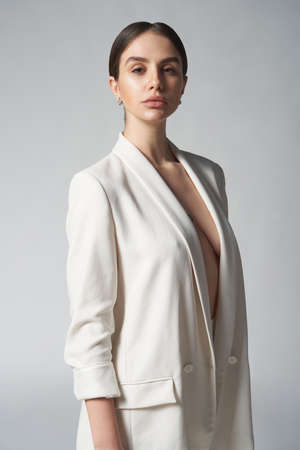 Fashion portrait of beautiful brunette woman in white jacketの写真素材