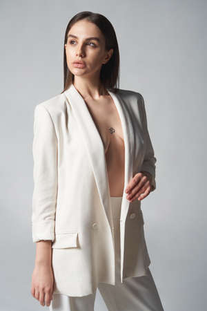 Fashion portrait of beautiful brunette woman in white jacketの写真素材