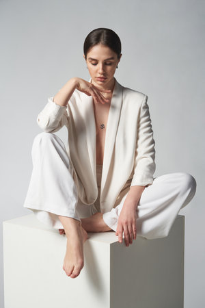 Fashion portrait of beautiful brunette woman in white jacketの写真素材