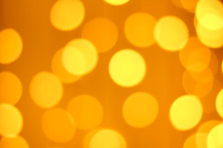 Defocused gold abstract christmas background. Golden and yellow circle backgroundの写真素材