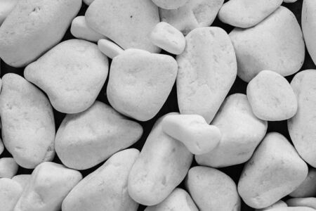 White pebbles background. White stones on a black backgroundの写真素材