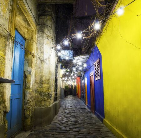 Nightlife at the medieval old part of the popular tourist city in Ireland. Narrow cobbled streets and pubs of the old city.の写真素材