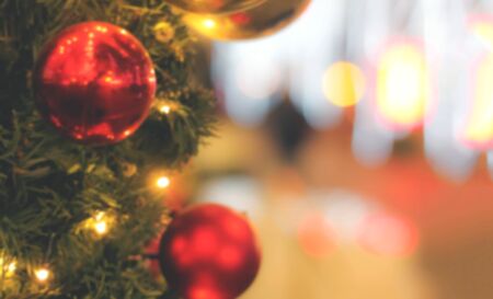 Blurred christmas tree with toys, garlands and lights. Pink shadeの写真素材