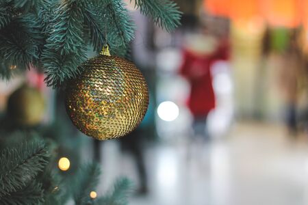 Close-up view of red and gold christmas ball on treeの写真素材