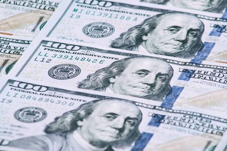 Background of one hundred dollar bills. Benjamin Franklin on USA money banknote.  American dollars...