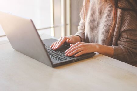 Woman working at home or office hands on keyboard  laptop. Remote work freelance. Close-up.