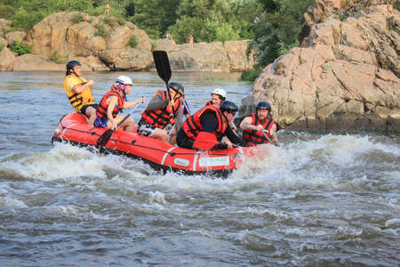 Mygiya / Ukraine - June 26 2018: Young person rafting on the river, extreme and fun sport at tourist attraction. Rafting on the  Pivdennyi Buh Riverのeditorial素材
