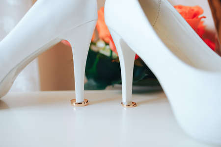 White bride shoes and wedding ringsの写真素材
