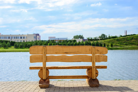 old wooden bench by the lake on a summer dayの写真素材