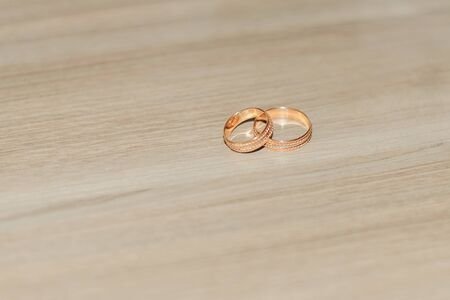 Wedding rings lie on the floorの写真素材