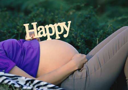 pregnant girl. Portrait of a pregnant woman relaxing in the parkの写真素材