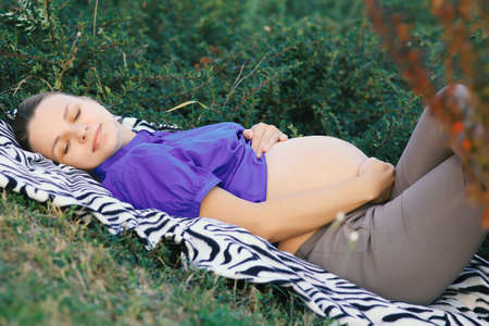 pregnant girl. Portrait of a pregnant woman relaxing in the parkの写真素材