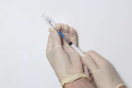 Doctor filling syringe with medication, closeup. Vaccination and immunization