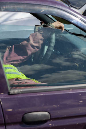 Closeup portrait tired young funny man in blue shirt with short attention span, driving his black...