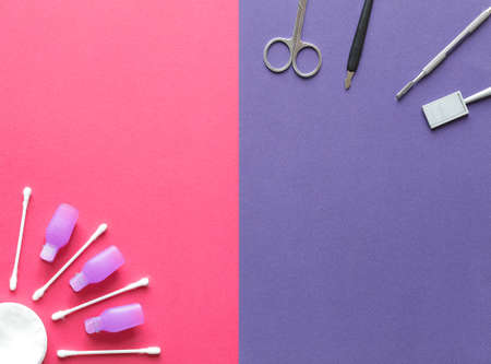 manicure set for shellac with cotton swabs and pads on a pink purple background close up